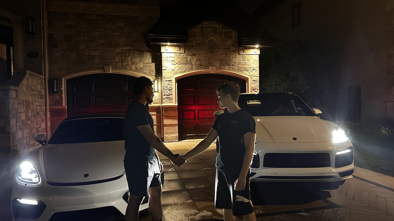Gleam Autocare team with freshly detailed cars at night