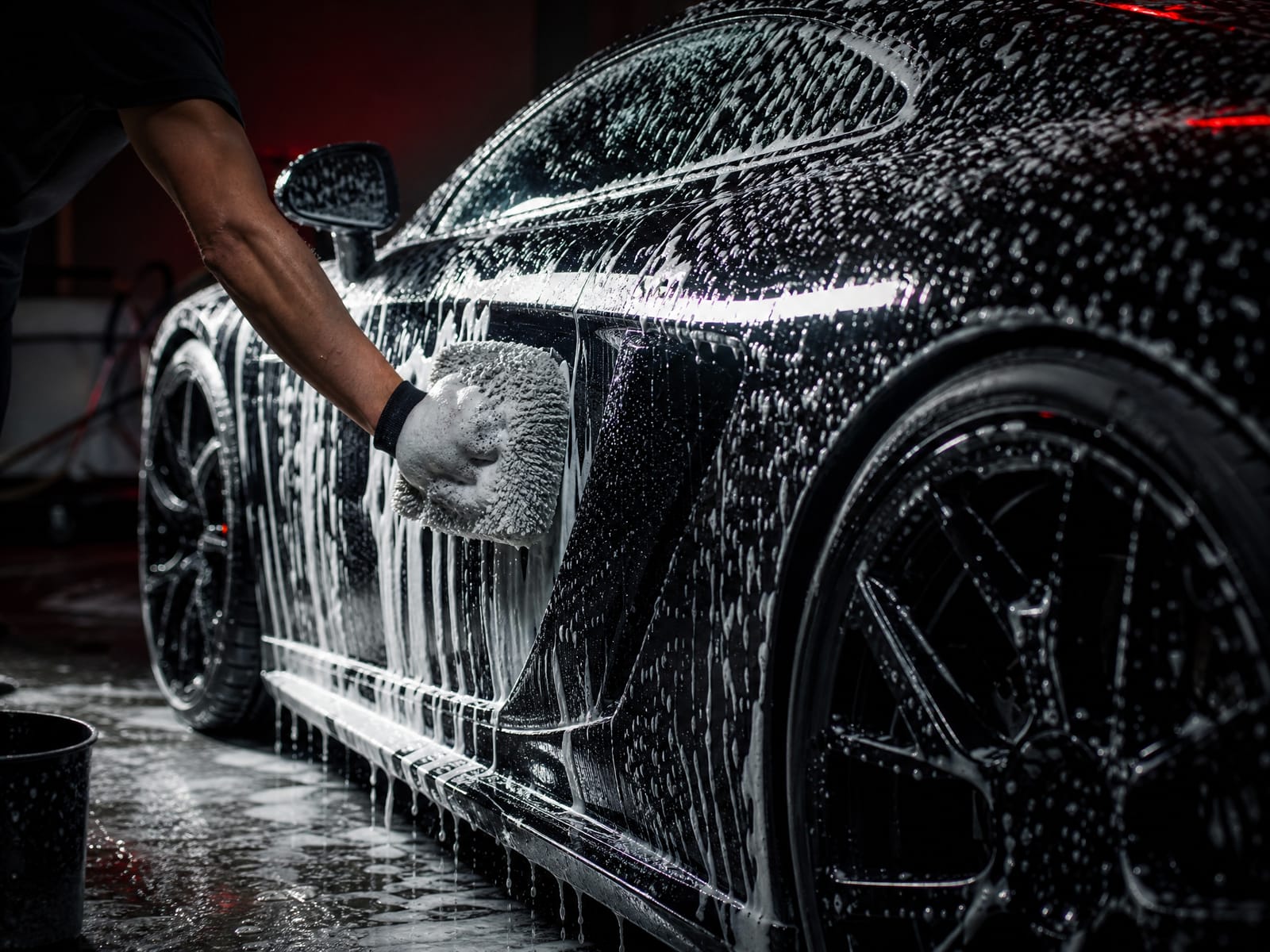 Luxury car exterior covered in foam during a hand wash