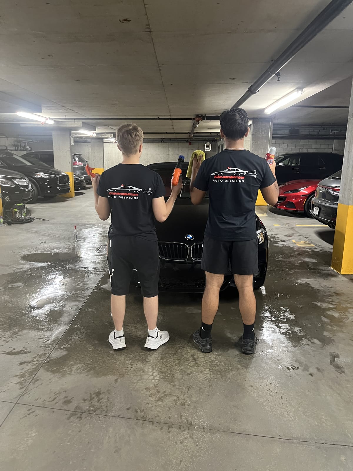 Professional Gleam detailer beside a gleaming luxury car